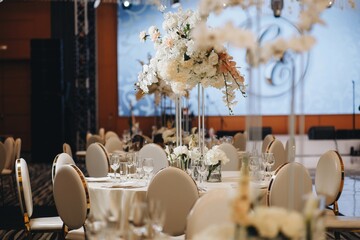 tableware Glasses, flower fork, knife served for dinner in restaurant with cozy interior