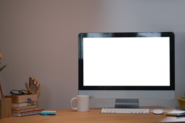 Front view of office desk with blank display computer.