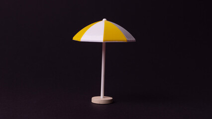 Fototapeta premium multi-colored plastic umbrella on a black background