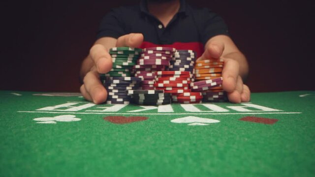 Male player betting all chips in while playing in casino, close up - Powered by Adobe