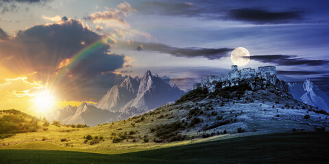Fototapeta day and night time change concept above the castle on the hill. composite fantasy landscape. grassy meadow in the foreground. rocky peaks of the ridge in the distant background with sun and moon obraz