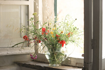 Field bouquet standing on a antic tuscan windowsill 