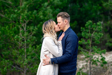 Fototapeta premium Happy loving couple kissing enjoying of happiness love and tenderness,romance.Couple hugging in love at spring park.