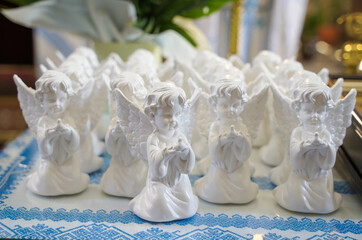 gifts for children in the form of a statuette of an angel. first confession and communion in the...