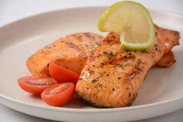 Fried salmon steaks. Cooked salmon steak with pepper, herbs, lemon, garlic, olive oil and Brussels sprouts. Grilled fresh fish.