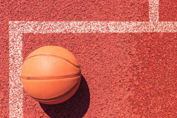 sport concept. old basketball on court.Top view orange ball for basketball lying on the rubber sport court.Copy space