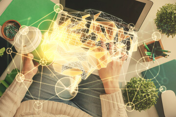 Double exposure of woman working on computer andhuman brain hologram drawing. Top View. Ai concept.
