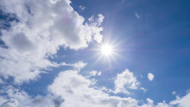 beautiful fluffy with  cumulus clouds in blue sky summer season. dramatic cloud covered bright sun star in clear good atmosphere day, cloudscape timelapse of power  sun beams, rays in midday, 