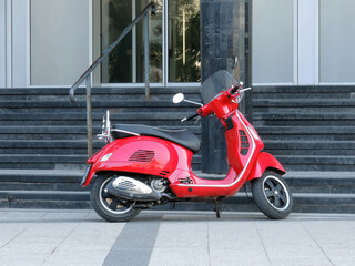 Red scooter near the stairs in urban environment