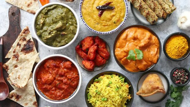 Assorted Indian various food with spices, rice and fresh vegetables