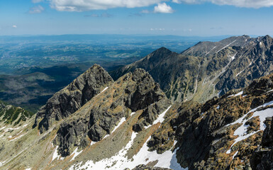 Fototapeta na wymiar Ridge Koscielcow in the Polish Tatras. A popular mountain climbing route among young adepts of mountain climbing. There is also a popular hiking trail leading to one of the peaks of this ridge.