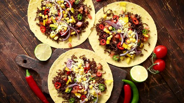 Healthy corn tortillas with grilled beef, fresh hot peppers, cheese, tomatoes