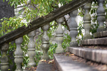 Staircase with antique and curly railings in the middle of the garden