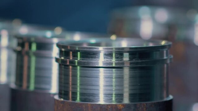 Close up of metal parts of a pipe fitting plant. Video. Metal new shiny bushings at the metallurgical factory.