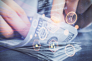 Double exposure of technology drawing hologram and us dollars bills and man hands. Data concept