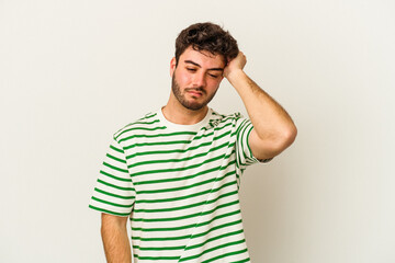 Obraz premium Young caucasian man isolated on white background forgetting something, slapping forehead with palm and closing eyes.