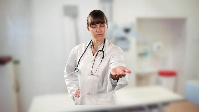 Caucasian female doctor holding an invisible object against hospital in background