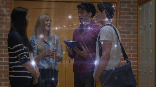 Glowing network of connections against group of college students talking to each other