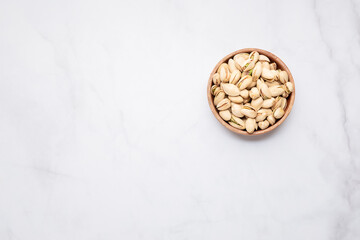 pistachios nuts in wooden bowl