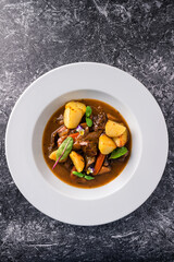 Irish Stew or Guinness Stew made in a crockpot or slow cooker top view, flat lay
