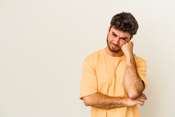 Fototapeta premium Young caucasian man isolated on white background who feels sad and pensive, looking at copy space.