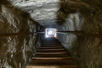Stairway of the tomb in the center of a pyramid at Giza, Cairo in Egypt. light at the end of the...