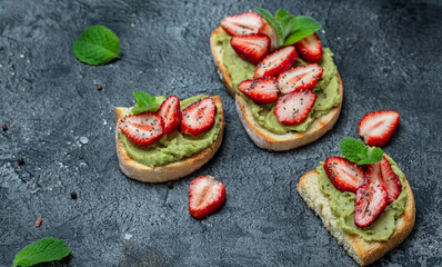 Avocado toast with strawberries and chia seeds, Keto diet toast. Vegan healthy food concept. Top view