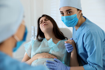 Woman giving child birth in maternity hospital