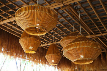 Wood pendant lamp tropical style installed on bamboo ceiling.