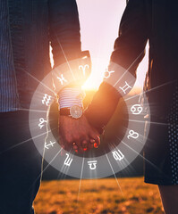 Couple holding hands at sunset. Concept of love compatibility between zodiac signs. Horoscope...