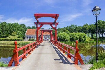 Red wooden bridge leading to the historic town of Bourtange