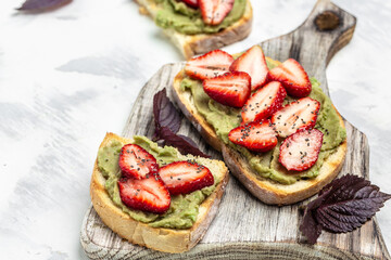 Toast with strawberry guacamole. and chia seeds. Keto diet toast. Delicious breakfast or snack, Clean eating, dieting, vegan food concept. top view