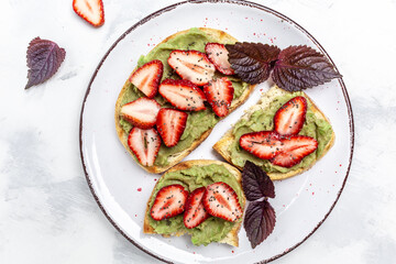 Toast with strawberry guacamole. and chia seeds. Keto diet toast. Delicious breakfast or snack, Clean eating, dieting, vegan food concept. top view