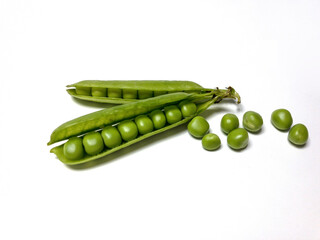 green peas in a pod in a corner on white background