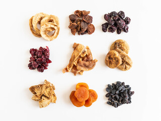 Various dried fruits heaps. Dried or sun-dried berries and fruits on white background.