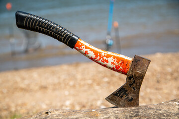 tourist ax stuck in a log close-up