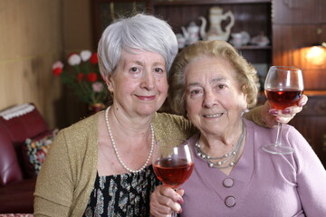 Fun senior women drinking wine  
