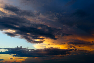 beautiful sunset sky, bright sunlight and silhouette of clouds as a background