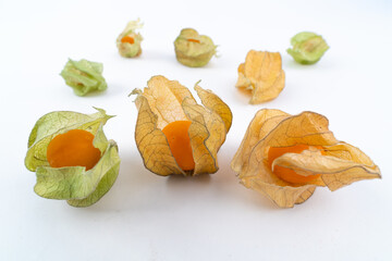 Many pieces of ripe physalis, or golden berry, or ground cherry, isolated on white background.