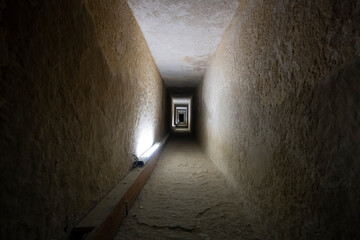 Tunnel entrance to the ancient Egyptian pyramid. A long passage in the pyramid of Giza. A prehistoric landmark. Giza, Cairo, Egypt. inside second pyramid. - obrazy, fototapety, plakaty
