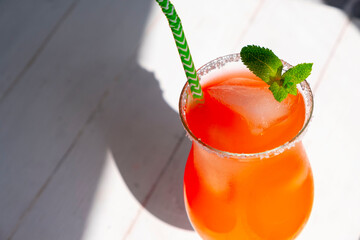 Orange cocktail ,Screwdriveror, or   Sunrise in a glass with ice on a white wooden background