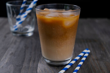 cold ice latte
 or coffee with milk on a dark black background