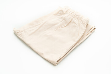 beige pant fold on white background