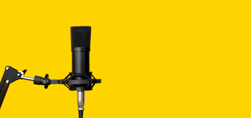 Studio microphone on yellow background.