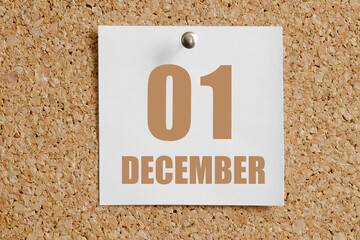 december 01. 01th day of the month, calendar date.White calendar sheet attached to brown cork...