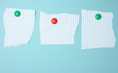 blank sheets of paper in a cage attached to a blue magnetic board