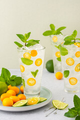 Cold refreshing drink with kumquats and mint, water with citrus fruits and ice