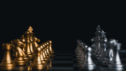 Gold and Silver king winner surrounded with silver chess pieces on chess board game competition.concept strategy, leadership and success business.