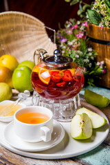 red fruit tea in a transparent teapot at the tea party ceremony