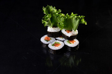 japanese cuisine rolls with reflection on black background